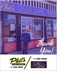 A man standing outside a restaurent that says Phil's Casula Dining. Two different Phil's logos with phone numbers are under the picture.