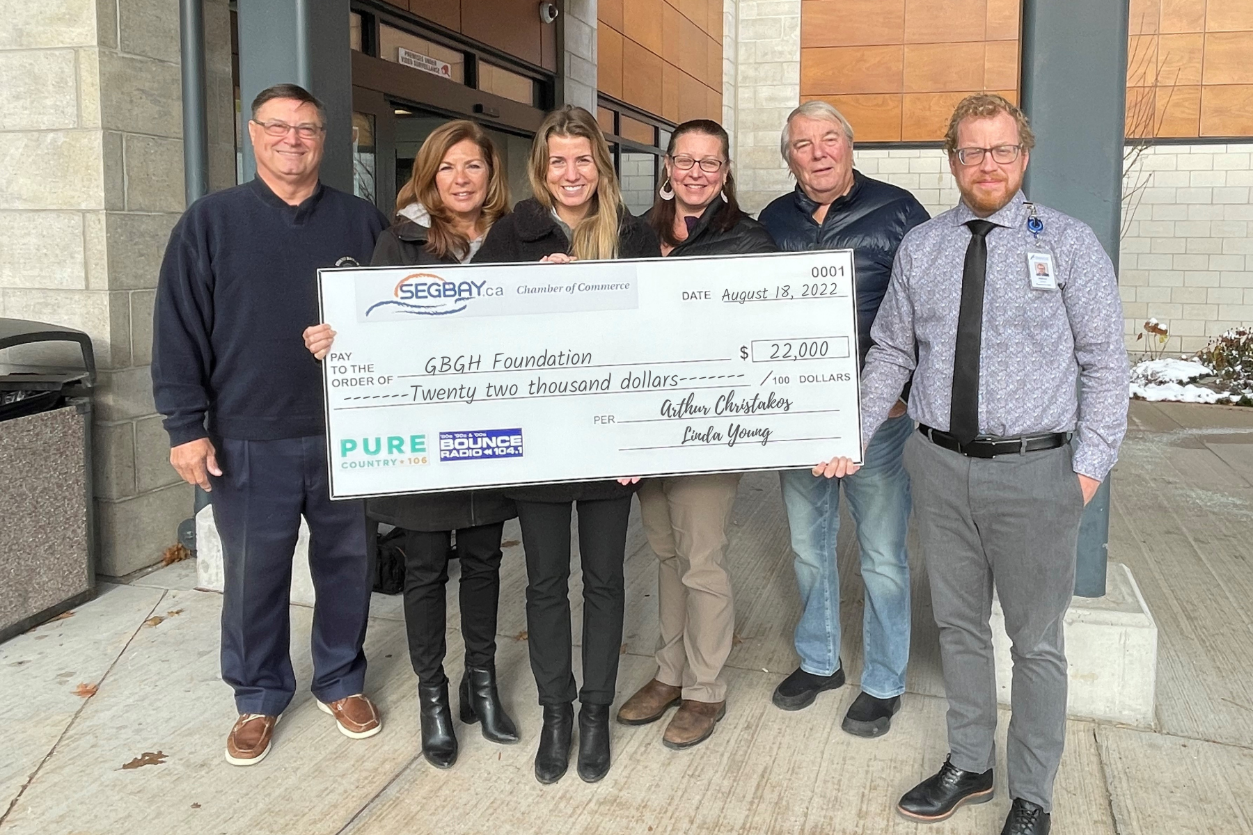 Three women and three men hold a giant cheque for $22,000 to the GBGH foundation from SE Georgian Bay Chamber of Commerces, Pure Country 106 and Bounce Radio 104.1