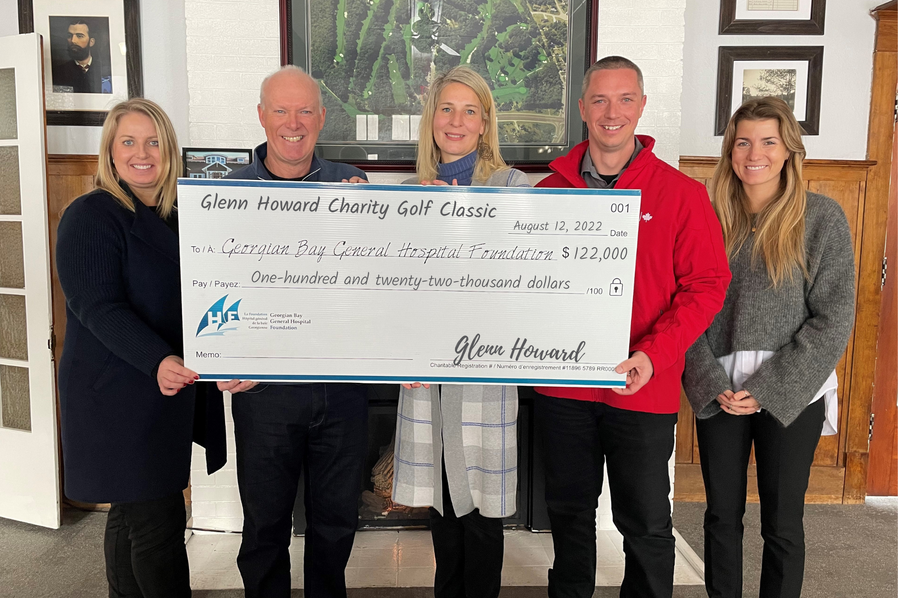 Two men and three women stand with a giant cheque for $122,000 for the GBGH Foundation from the Glenn Howard Charity Golf Classic