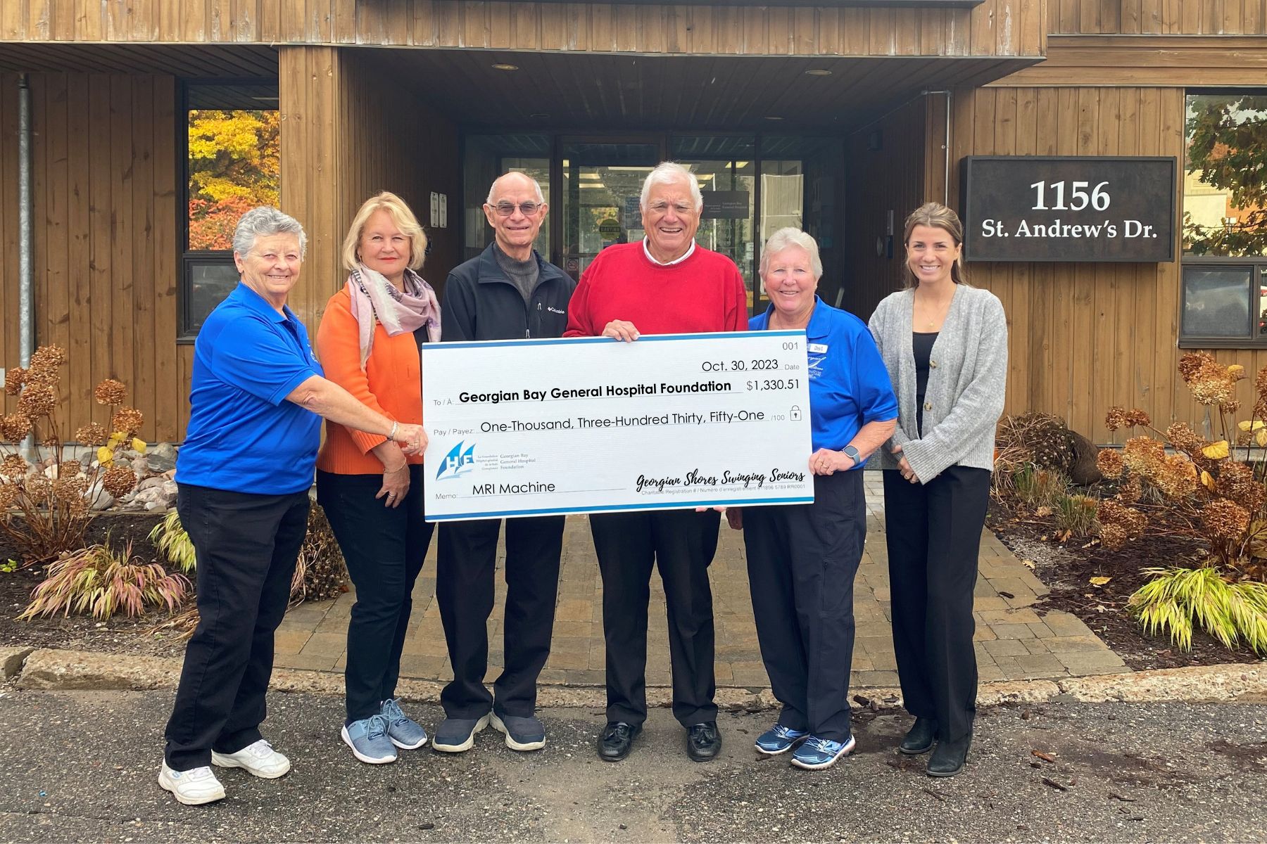 Four women and two men hold a giant cheque made out to GBGH Foundation for $1, 330.51 from Georgian Shores Swinging Seniors