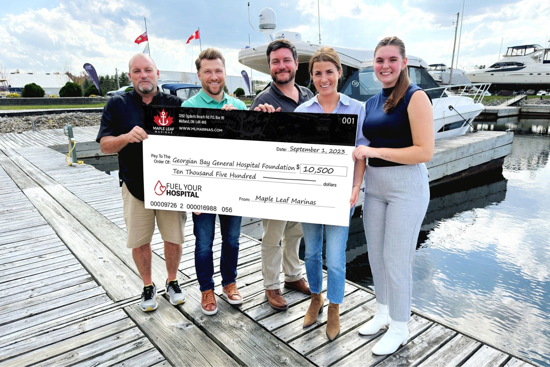 Two women and three men hold a giant cheque made out to GBGH Foundation for $10, 500 Fuel Your Hospital - Maple Leaf Marina