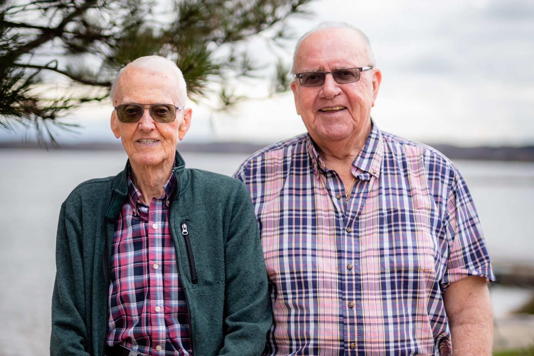 Two older men wearing plaid shirts