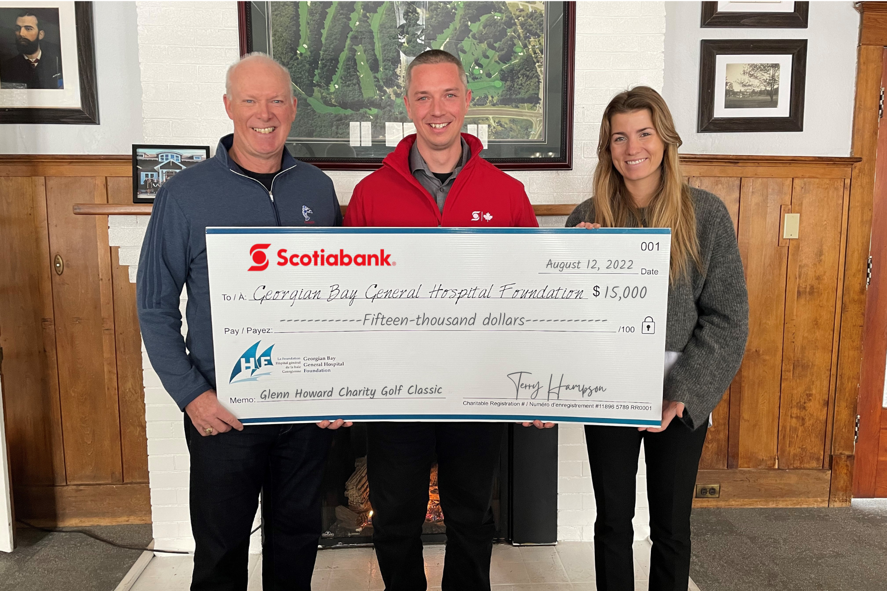 Two men and a women hold a giant cheque made out to GBGH Foundation for the Glenn Howard Charity Golf Classic for $15,000 from Scotiabank