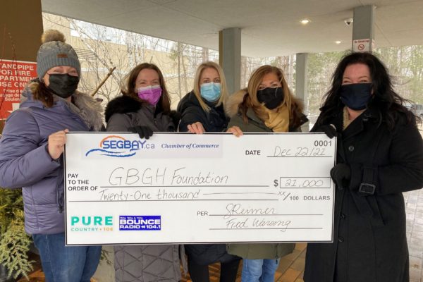 Five women holding up a cheque for $21,000 to the GBGH foundation from Pure Country and Rock 95
