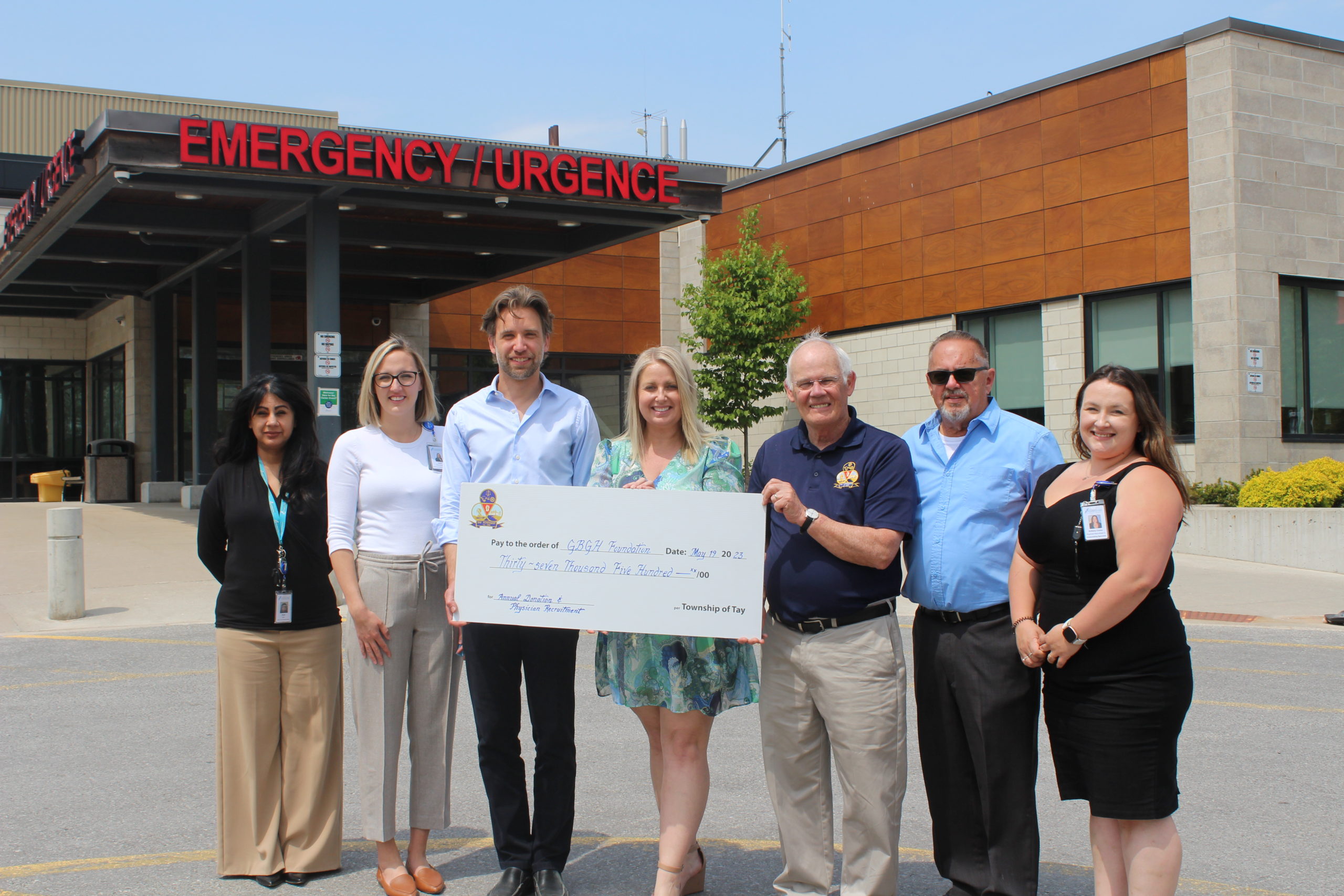 Four women and Three men hold a giant cheque for GBGH Foundation from the Township of Tay