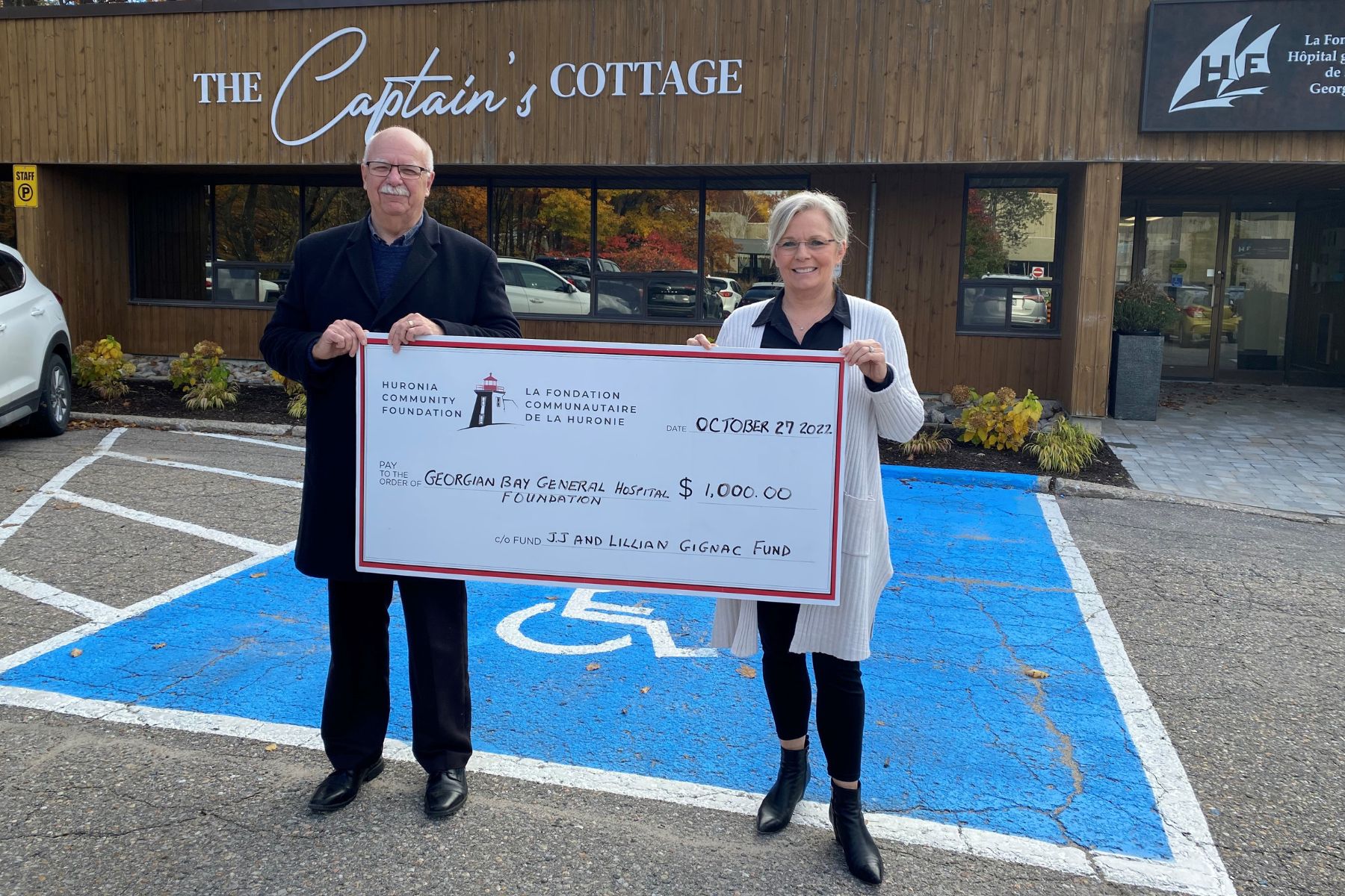 A man and woman holding a giant cheque for $1,000 made out to GBGH Foundation from Jj ans Lillian Gignac fund
