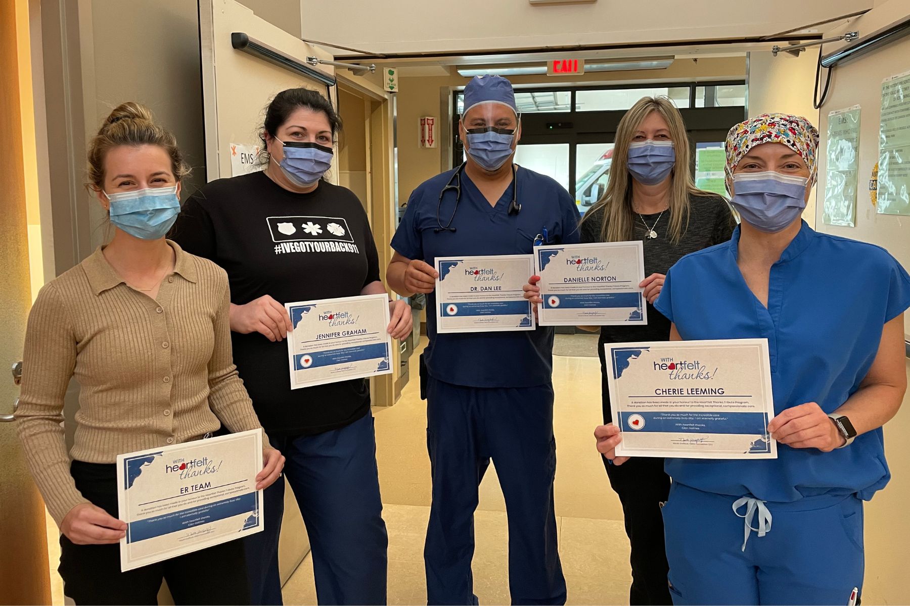 Five workers at GBGH hold up With Heartfelt Thanks Award certificates