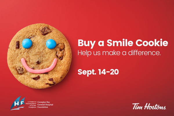 Chocolate chip cookie with blue eyes and a pink smile with words Buy a Smile Cookie Help Up Make a Difference Sept 12-20