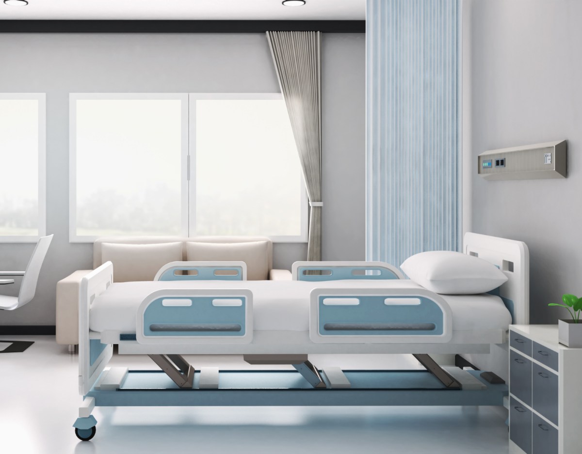 tidy hospital bed in a well lit room